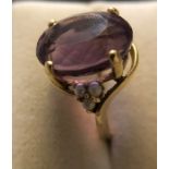 An amethyst and seed pearl ladies dress ring marked .585 set in yellow gold (14 carat) Size P. 7.