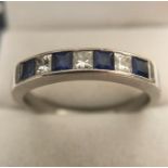 A Pravins platinum diamond and sapphire ring, size Z, 8.3gms.
