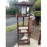 A tile backed hallstand with central mirror.