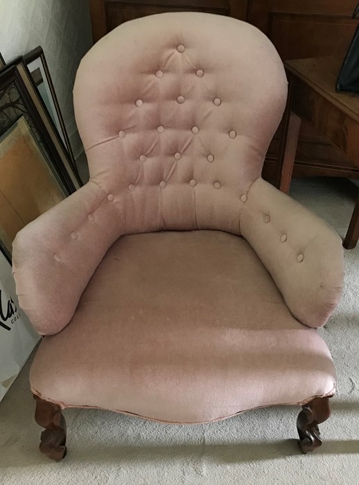 A Victorian cabriole legged nursing chair on castors, upholstered in pink velvet.