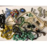 A quantity of costume jewellery in a jewellery box to include sterling silver and enamel brooches,
