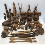 A large collection of African carved wooden animals and tribal figures, letter openers, birds,