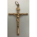 A 9 ct gold crucifix. 2.4gms. 5cms l.