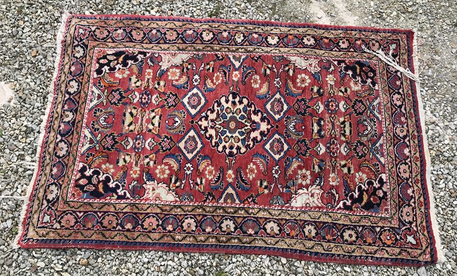 Red patterned Persian rug. 156 x 101cms. Condition ReportThread bare tassels.