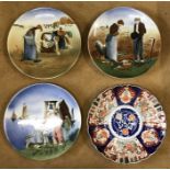 Four hand painted glazed wall mounted plates to include 3 Dutch scenes of muted brown and blue and a