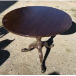 Mahogany circular tip top table on tripod base and pad feet. 85 w x 72cms h.