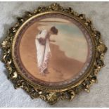 A pair of early 20thC prints in fine quality carved and gilt wooden frames., a young lady on the