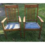 Pair of oak slat back armchairs, drop in seats. Condition ReportOne arm loose at the joint.