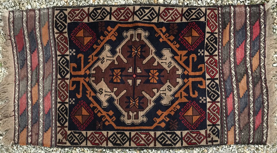 Blue and brown patterned Persian rug. 155 x 82cms.