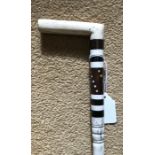 Whalebone carved walking stick with ebony and wood sections. 91cms l, handle 7.5cms w.