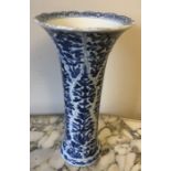 A Chinese moulded porcelain blue & white sleeve vase with all over foliage pattern in moulded