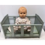 Large plastic sleepy eye doll, approx 60cms h, fault to the head and a blue painted dolls cot bed.