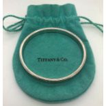 A vintage Tiffany silver bangle of typical round form with engraved T & Co, the interior marked 1997