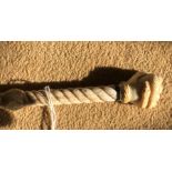 Whalebone carved walking stick, rope twist shaft with clenched fist holding snake handle. 86cms l,