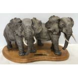 Large pottery figurine, Elephants have right of way, on wooden base. 22cms h. 42cms w of base.