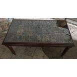 Mahogany rectangular coffee table with printers block alphabet and numbers under a glass top. 103