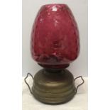 A brass and cranberry glass lamp, 47cms h.