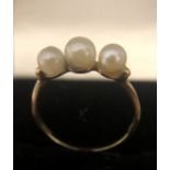 A 9ct yellow gold ring set with 3 pearls, size N/O. 1.3gms.