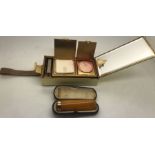 A Lady's Park Lane combination compact and cigarette holder with contents and an amber and gold