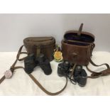 Two pairs of vintage binoculars in leather cases, Bausch and Lomb and Dollond, London