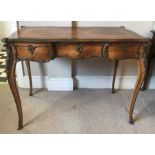 A French style Bureau Plat, raised on cabriole legs with sabot feet, decorative brass mounts