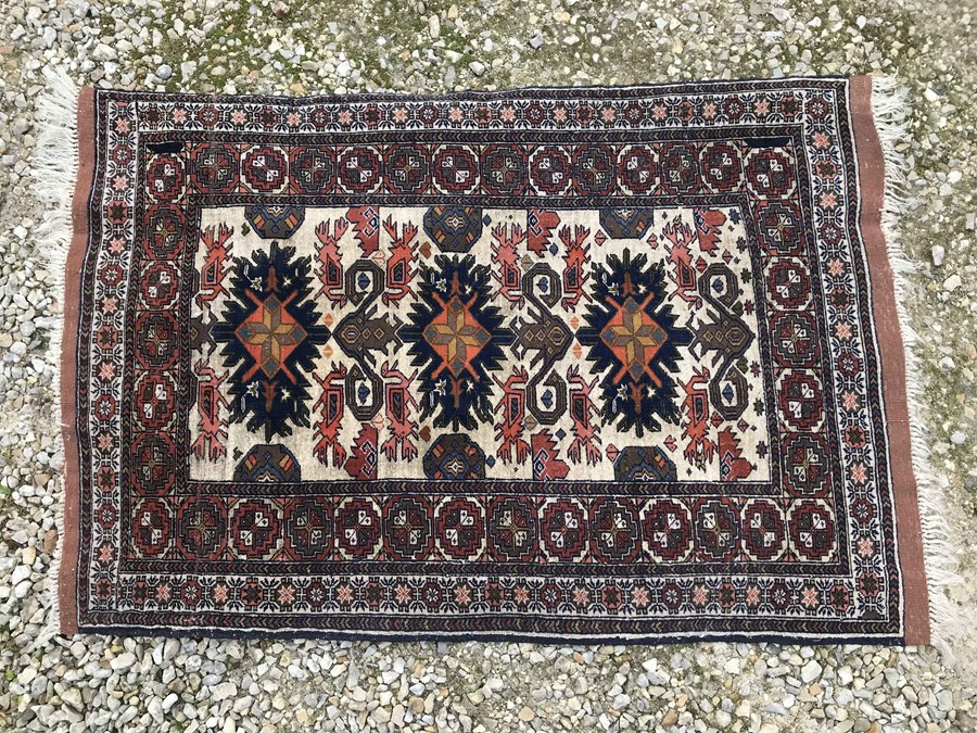 Brown patterned Persian rug, central panel with 6 blue pattern design. 116 x 79cms.Condition