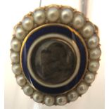 A 19thC mourning ring, hair locket to centre with blue and white enamel surrounded by natural