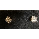 A pair of 9ct white gold and diamond stud earrings.
