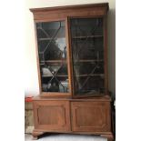 A 2 height mahogany bookcase with cupboard base and glazed doors to top. 230 h x 125 w x 47cms d.