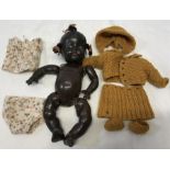 Composition black doll, 30cms l approx, A Reliable Doll, Canada, with wool clothing. Condition