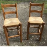 A pair of good quality modern bar stools with rush seats.