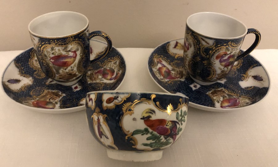 Two coffee cans and saucers and a tea cup scale blue with exotic birds probably Samson late 19th