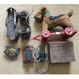 Pull along soft toy terrier dog, roller skates, electric shock machine and a AA grill badge.