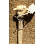 Whalebone walking stick, rope twist shaft with clenched fist holding scroll handle. 81cms l,