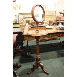 A GENTLEMAN'S DRESSING STAND, with adjustable mirror, raised on turned column support on a tripod