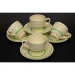 A SET OF CLARICE CLIFF TEA/COFFEE CUPS, with saucers, Newport Pottery, Reg. No. 840076, with green &