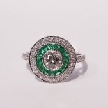 AN 18CT WHITE GOLD EMERALD & DIAMOND 'TARGET' RING, centre diamond .58ct