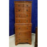 A GOOD QUALITY SERPENTINE SHAPED YEW WOOD CHEST ON CHEST, with brush slide, canted corners to the