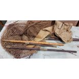 A COLLECTION OF FISHING NETS AND ROD COVERS, with wood & brass adjustable poles and harpoon tip