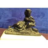A BRONZE FIGURE OF A GIRL SEATED READING, on a marble base, 10" wide approx