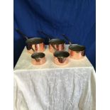 A SET OF 5 COPPER SAUCEPANS