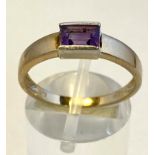 A 9CT YELLOW GOLD AMETHYST, hallmarked, with amethyst centre stone, a very elegant ring finished