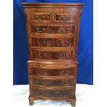 A VERY FINE BOW FRONTED CHEST ON CHEST, with crossbanded detail, 5 drawers over slide drawer over