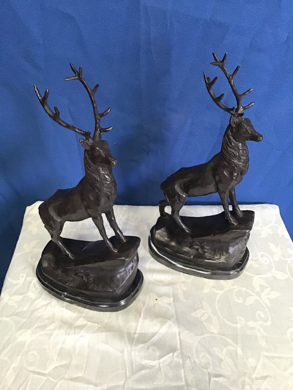 A PAIR OF CAST BRONZE COLOURED STAGS, with incised name to base, 36 x37 approx. each
