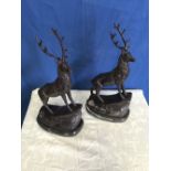 A PAIR OF CAST BRONZE COLOURED STAGS, with incised name to base, 36 x37 approx. each