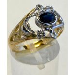 AN 18CT YELLOW & WHITE GOLD HAND MADE RING, set with an exquisite sapphire in a Celtic design band