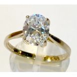 A 9CT YELLOW GOLD RING, hallmarked, with large oval cubic Zirconia in a 4 claw setting, ring size: O