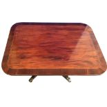 A GOOD QUALITY REGENCY MAHOGANY COFFEE TABLE, with crossbanded top, on a four shoot base on brass