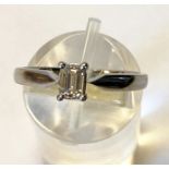 A PLATINUM EMERALD CUT SOLITAIRE DIAMOND RING, hallmarked, diamond weight .30 cts in a four claw