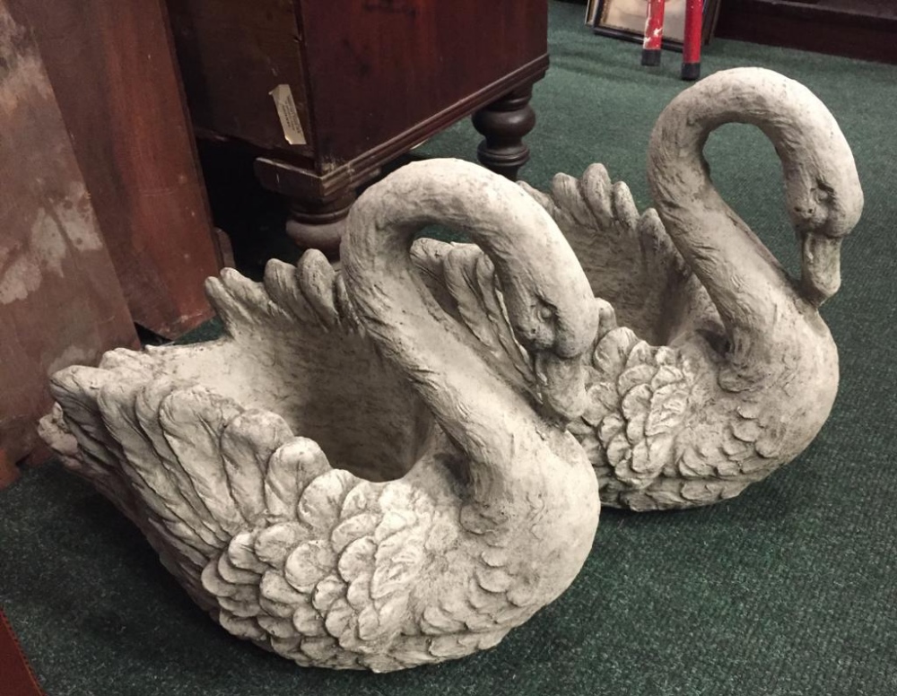 A PAIR OF GARDEN ORNAMENTS / STONE JARDINIÈRE POTS IN THE FORM OF SWANS, 16" tall approx, 18" wide